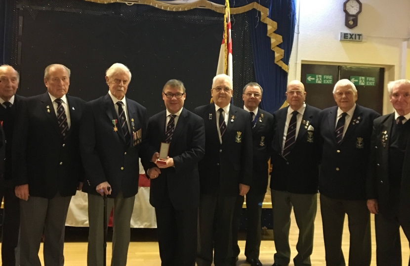Rayleigh and Wickford MP Mark Francois presenting the Legion d’Honneur to Second World War veteran Mr Alan Iles in front of his fellow ship mates from the Rayleigh Royal Naval Association.