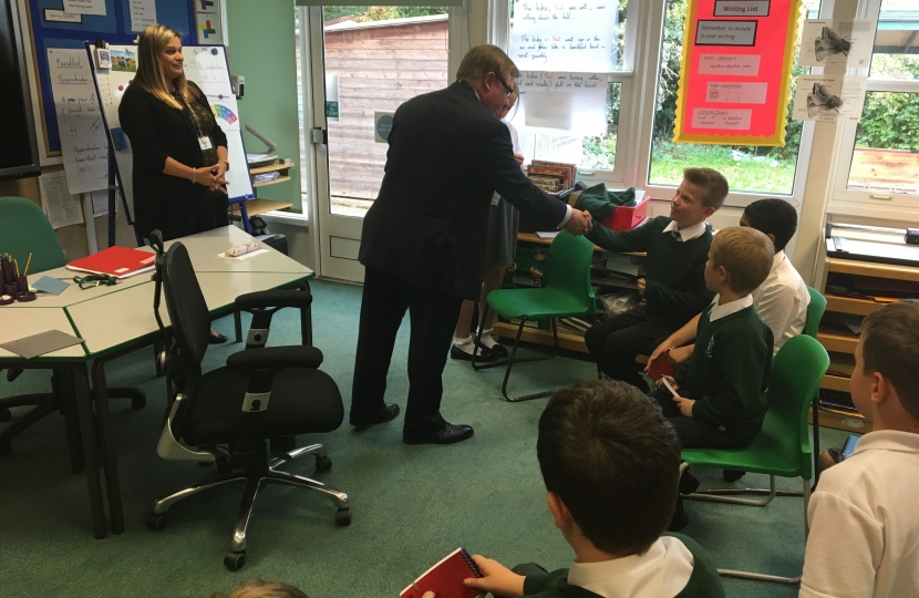Rayleigh and Wickford MP Mark Francois handing out badges to newly elected School Councillors during his recent visit to Glebe Primary School in Rayleigh.