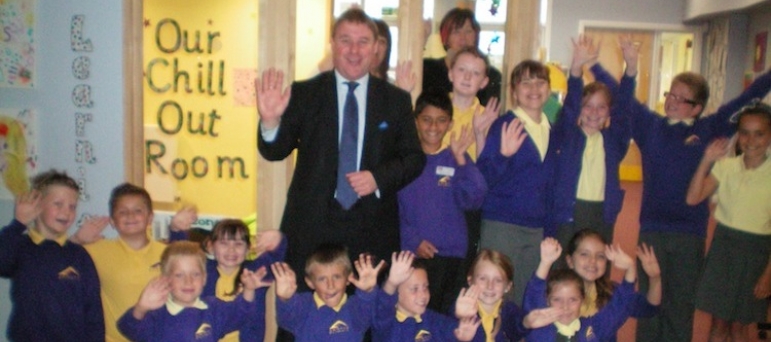 Mark Francois with Headteacher Miss Danniells, staff and pupils outside the special chill out room, which he saw during a recent visit to Abacus Primary School in his constituency